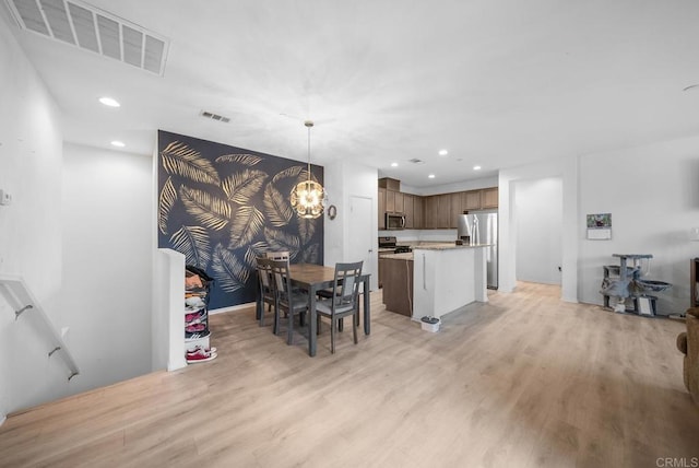 dining room featuring recessed lighting, visible vents, and light wood-type flooring