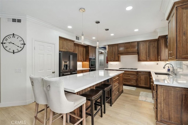 35183 Flamingo Way, Winchester, CA 92596 - kitchen with high end refrigerator, a sink, a center island, light wood-type flooring, and a kitchen bar
