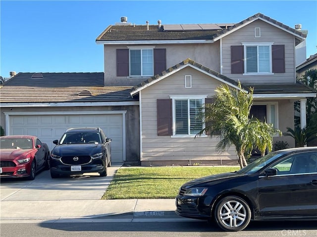 traditional-style house featuring driveway, roof mounted solar panels, a garage, and a tiled roof