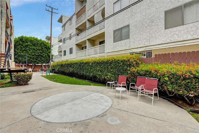 view of property's community with a patio area