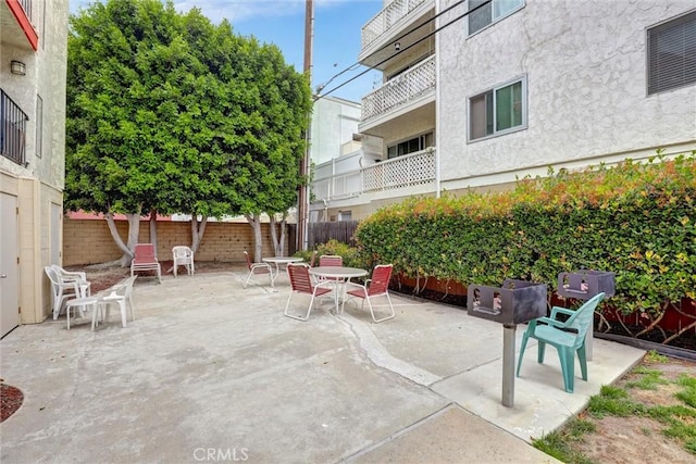 view of patio with fence and outdoor dining space