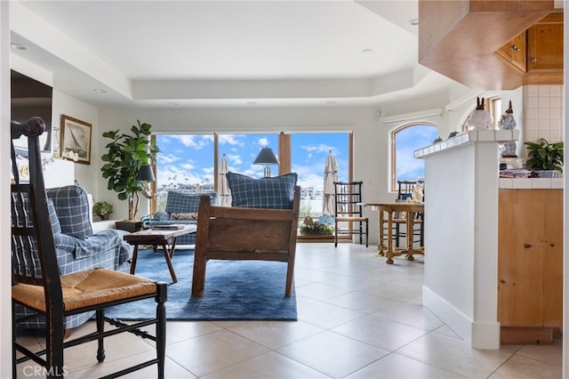 300302 S Bayfront, Newport Beach, CA 92662 - living area featuring baseboards, light tile patterned flooring, and a tray ceiling