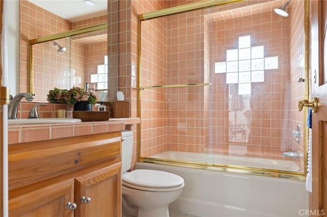 300302 S Bayfront, Newport Beach, CA 92662 - full bath with tile walls, vanity, toilet, combined bath / shower with glass door, and tile patterned flooring