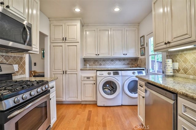 1956 E Woodlyn Rd, Pasadena, CA 91104 - kitchen featuring washing machine and clothes dryer, light stone countertops, appliances with stainless steel finishes, light wood-style flooring, and backsplash