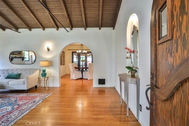1956 E Woodlyn Rd, Pasadena, CA 91104 - foyer entrance with wood ceiling, visible vents, arched walkways, a notable chandelier, and light wood-style flooring