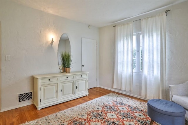 1956 E Woodlyn Rd, Pasadena, CA 91104 - living area with visible vents, light wood finished floors, and baseboards