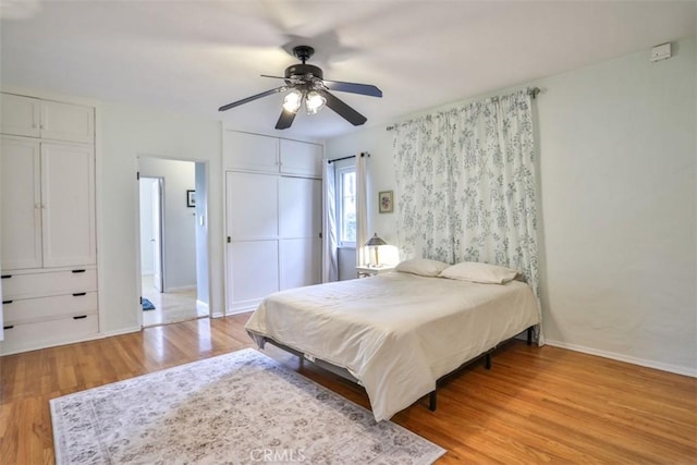 1956 E Woodlyn Rd, Pasadena, CA 91104 - bedroom featuring light wood-style floors, baseboards, ceiling fan, and multiple closets