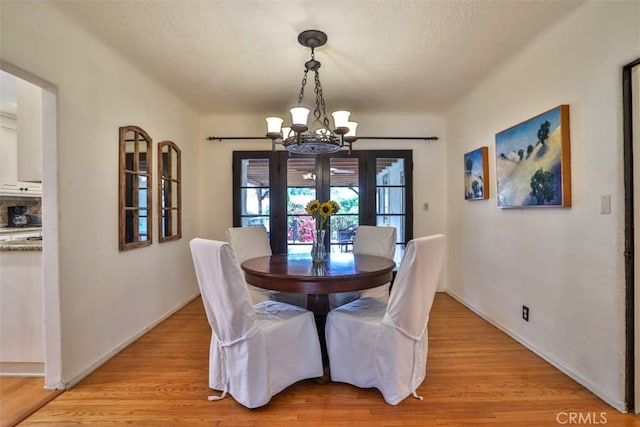 1956 E Woodlyn Rd, Pasadena, CA 91104 - dining room featuring baseboards, a notable chandelier, and light wood-type flooring