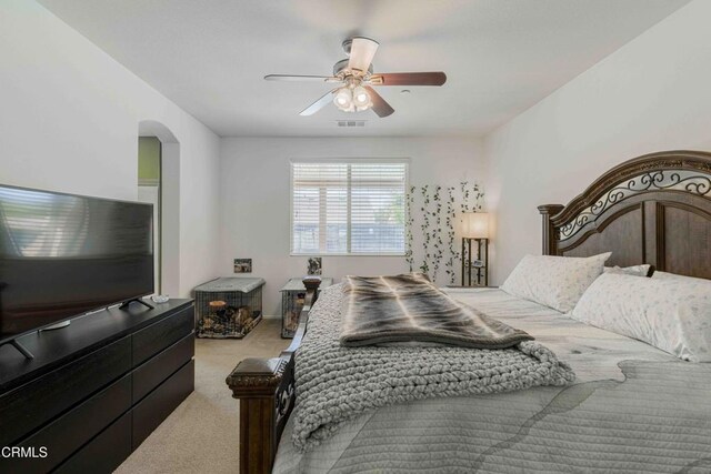 10909 Rainwater Ln, Bakersfield, CA 93306 - carpeted bedroom featuring arched walkways, visible vents, and a ceiling fan