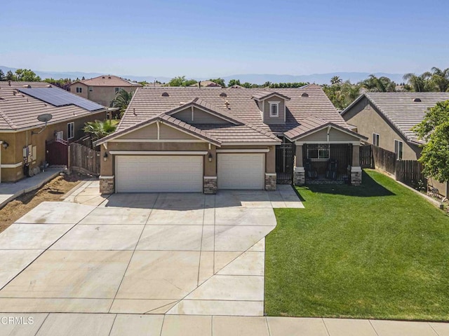 10909 Rainwater Ln, Bakersfield, CA 93306 - view of front of house with fence, concrete driveway, a front lawn, and stone siding