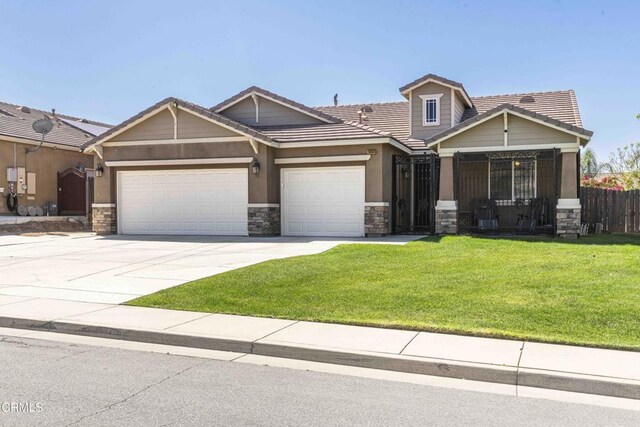 10909 Rainwater Ln, Bakersfield, CA 93306 - view of front of property with stone siding, an attached garage, a tiled roof, and driveway