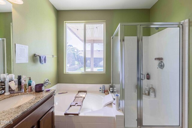 10909 Rainwater Ln, Bakersfield, CA 93306 - full bathroom with vanity, a bath, and a stall shower