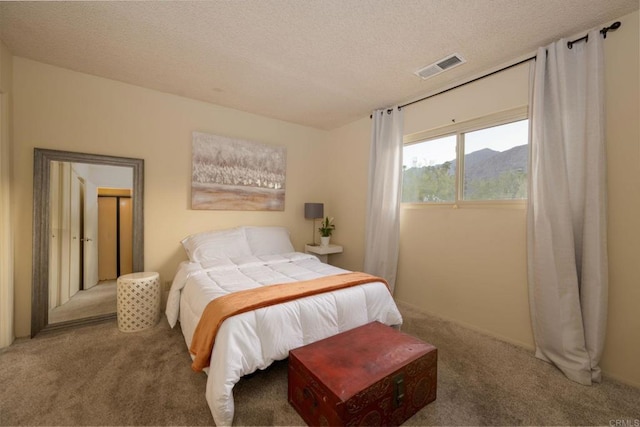 carpeted bedroom featuring a textured ceiling