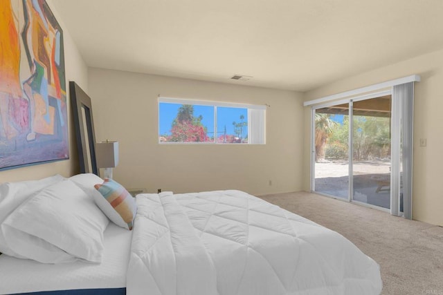 carpeted bedroom featuring access to exterior