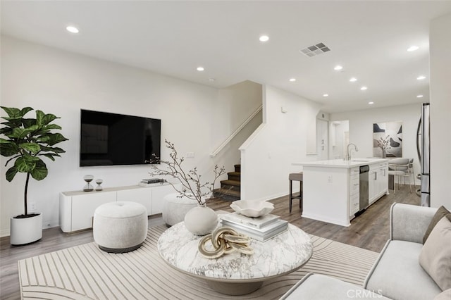 15331 Jasmine Ln Unit 105, Gardena, CA 90249 - living room with wood finished floors, recessed lighting, stairs, and baseboards