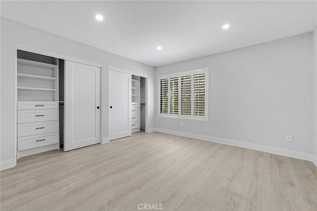 20500 Blairmoore St, Chatsworth, CA 91311 - unfurnished bedroom featuring two closets, light wood-style flooring, baseboards, and recessed lighting