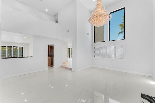 20500 Blairmoore St, Chatsworth, CA 91311 - unfurnished living room featuring baseboards, a towering ceiling, recessed lighting, and marble finish flooring