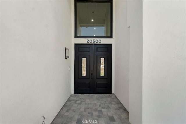 20500 Blairmoore St, Chatsworth, CA 91311 - view of exterior entry with stucco siding and french doors
