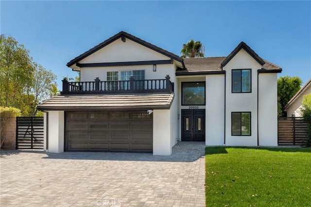 20500 Blairmoore St, Chatsworth, CA 91311 - view of front of home with a balcony, stucco siding, decorative driveway, and an attached garage
