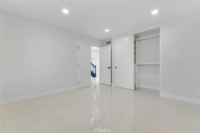 20500 Blairmoore St, Chatsworth, CA 91311 - unfurnished bedroom with marble look tiles, baseboards, recessed lighting, and a closet