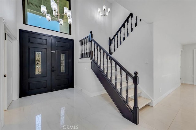 20500 Blairmoore St, Chatsworth, CA 91311 - entryway featuring a chandelier, marble tiled flooring, a towering ceiling, baseboards, and stairway