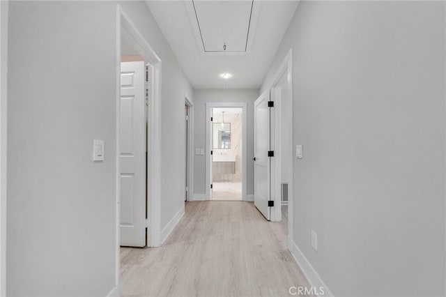 20500 Blairmoore St, Chatsworth, CA 91311 - corridor with attic access, light wood-type flooring, and baseboards