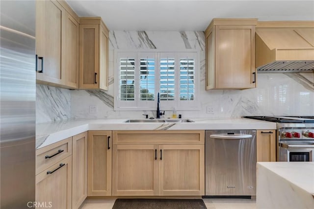 20500 Blairmoore St, Chatsworth, CA 91311 - kitchen featuring appliances with stainless steel finishes, light brown cabinets, a sink, wall chimney exhaust hood, and decorative backsplash
