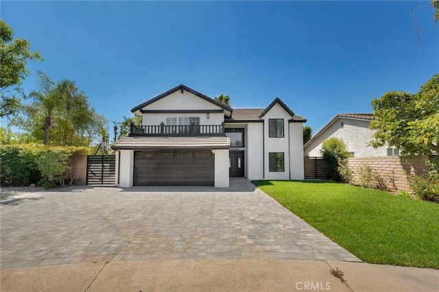 20500 Blairmoore St, Chatsworth, CA 91311 - view of front facade with a balcony, stucco siding, decorative driveway, a garage, and a gate