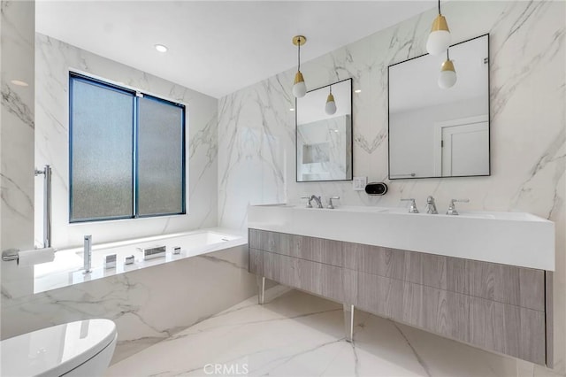 20500 Blairmoore St, Chatsworth, CA 91311 - bathroom featuring double vanity, a bath, toilet, marble tiled flooring, and stone wall