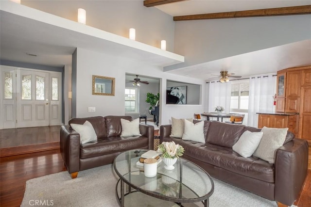 living room with ceiling fan, a wealth of natural light, wood finished floors, and high vaulted ceiling