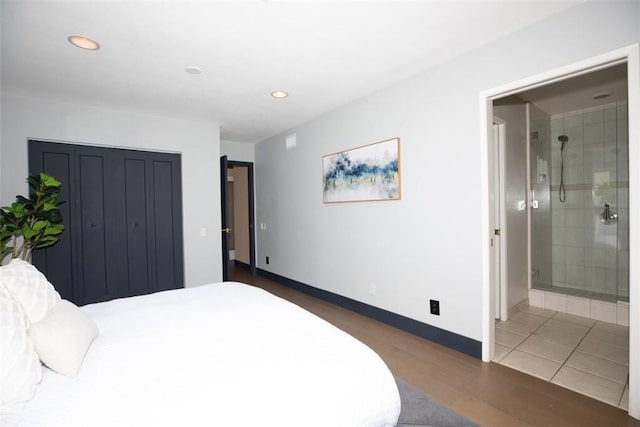 bedroom featuring wood finished floors, recessed lighting, ensuite bath, and baseboards