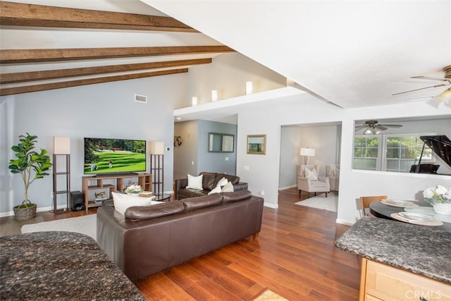 living room featuring wood finished floors, visible vents, a ceiling fan, and vaulted ceiling with beams