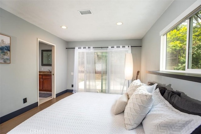 bedroom with connected bathroom, visible vents, baseboards, recessed lighting, and wood finished floors