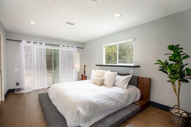 bedroom featuring recessed lighting, visible vents, wood finished floors, and baseboards