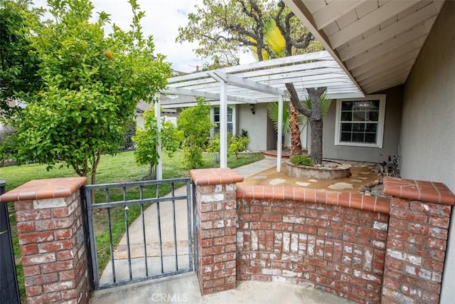 view of patio featuring a gate, fence, covered porch, and a pergola