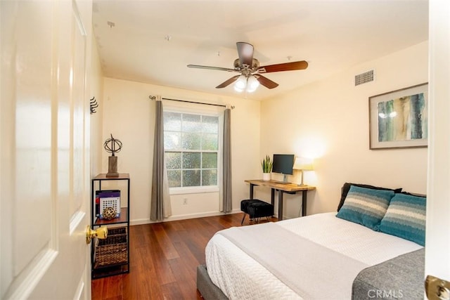 bedroom with baseboards, visible vents, wood finished floors, and a ceiling fan