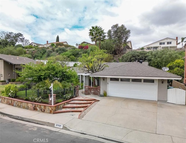 ranch-style house with driveway, stucco siding, a shingled roof, an attached garage, and fence