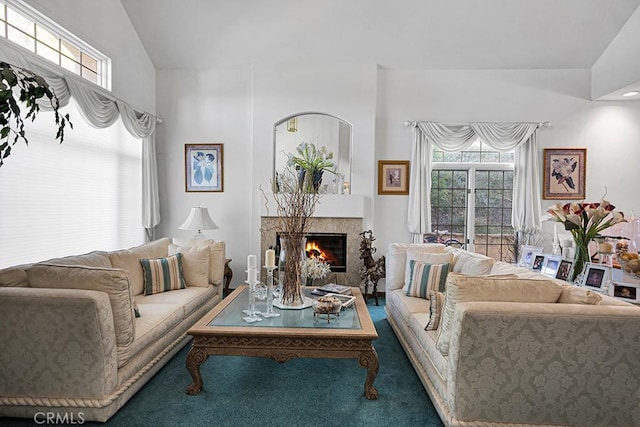 living room featuring a healthy amount of sunlight, carpet, and a glass covered fireplace