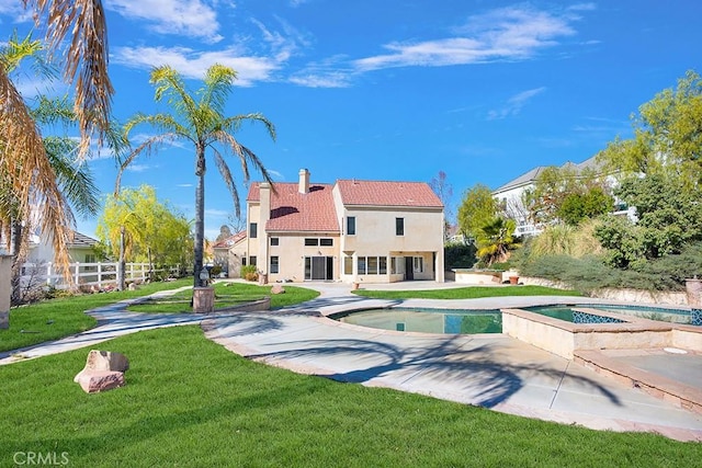rear view of property with a tile roof, an outdoor pool, stucco siding, and an in ground hot tub