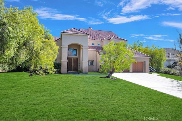mediterranean / spanish house featuring concrete driveway, stucco siding, and a tiled roof