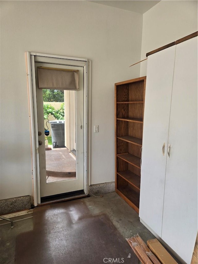doorway featuring unfinished concrete floors