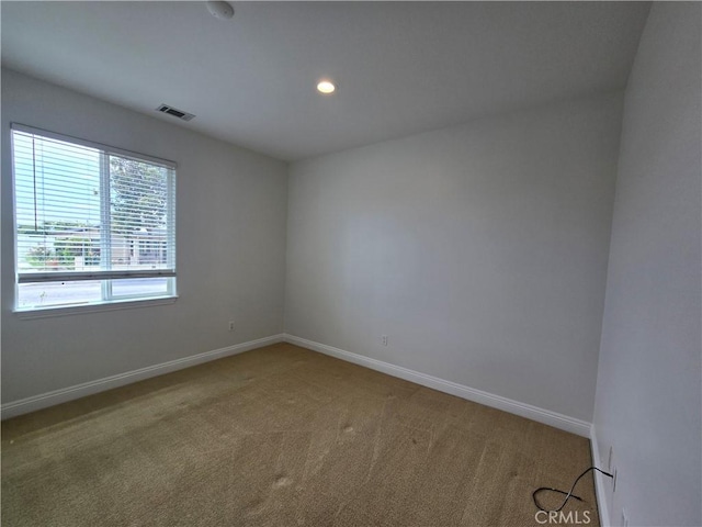unfurnished room with visible vents, baseboards, recessed lighting, and carpet floors