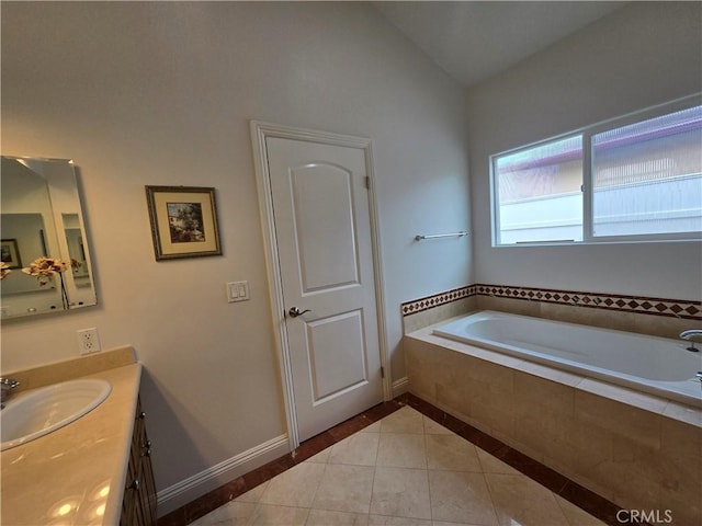 bathroom with vanity, a bath, tile patterned floors, baseboards, and lofted ceiling