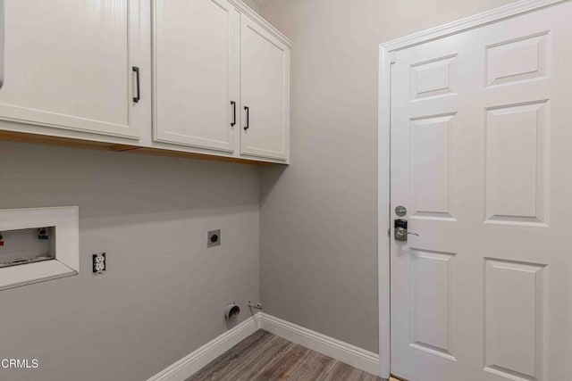 washroom featuring electric dryer hookup, baseboards, hookup for a washing machine, cabinet space, and wood finished floors