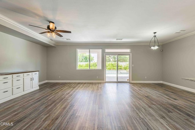 spare room featuring dark wood-style floors, baseboards, ceiling fan, and crown molding