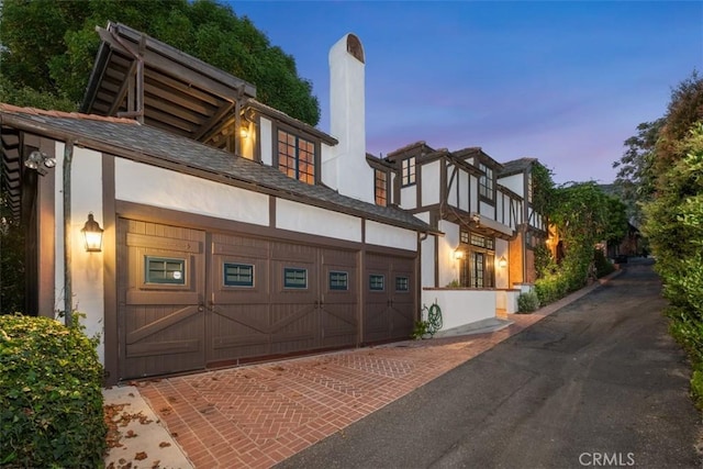 421 High Dr, Laguna Beach, CA 92651 - view of front of property featuring a chimney, driveway, stucco siding, and an attached garage