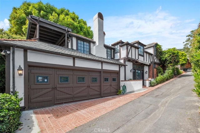 421 High Dr, Laguna Beach, CA 92651 - view of front of home featuring stucco siding, a chimney, driveway, and a garage