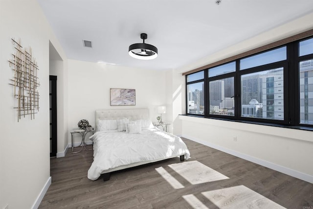 1551 4th Ave Unit 611, San Diego, CA 92101 - bedroom featuring visible vents, a city view, baseboards, and wood finished floors