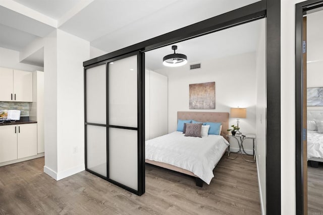 1551 4th Ave Unit 611, San Diego, CA 92101 - bedroom with baseboards, visible vents, and light wood-style floors
