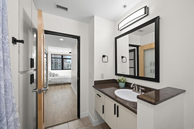 1551 4th Ave Unit 611, San Diego, CA 92101 - full bath with visible vents, tile patterned flooring, vanity, baseboards, and connected bathroom